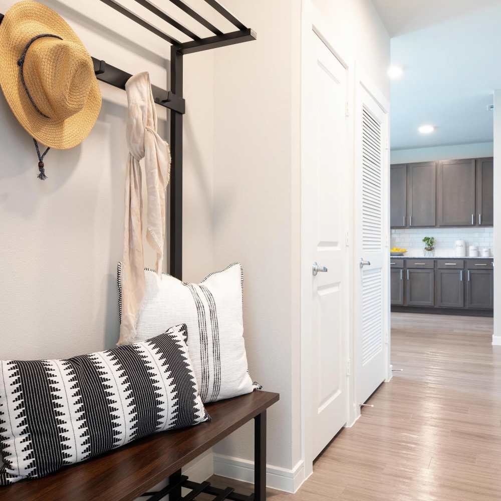 Welcoming entryway with stylish seating at August Friendswood in Friendswood, Texas