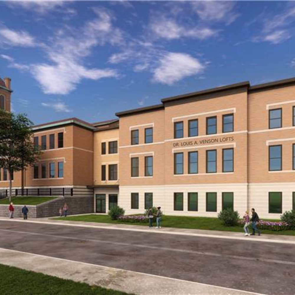 Community exterior building with sidewalk at Dr. Louis A. Venson Senior Lofts in Pittsburgh, Pennsylvania 