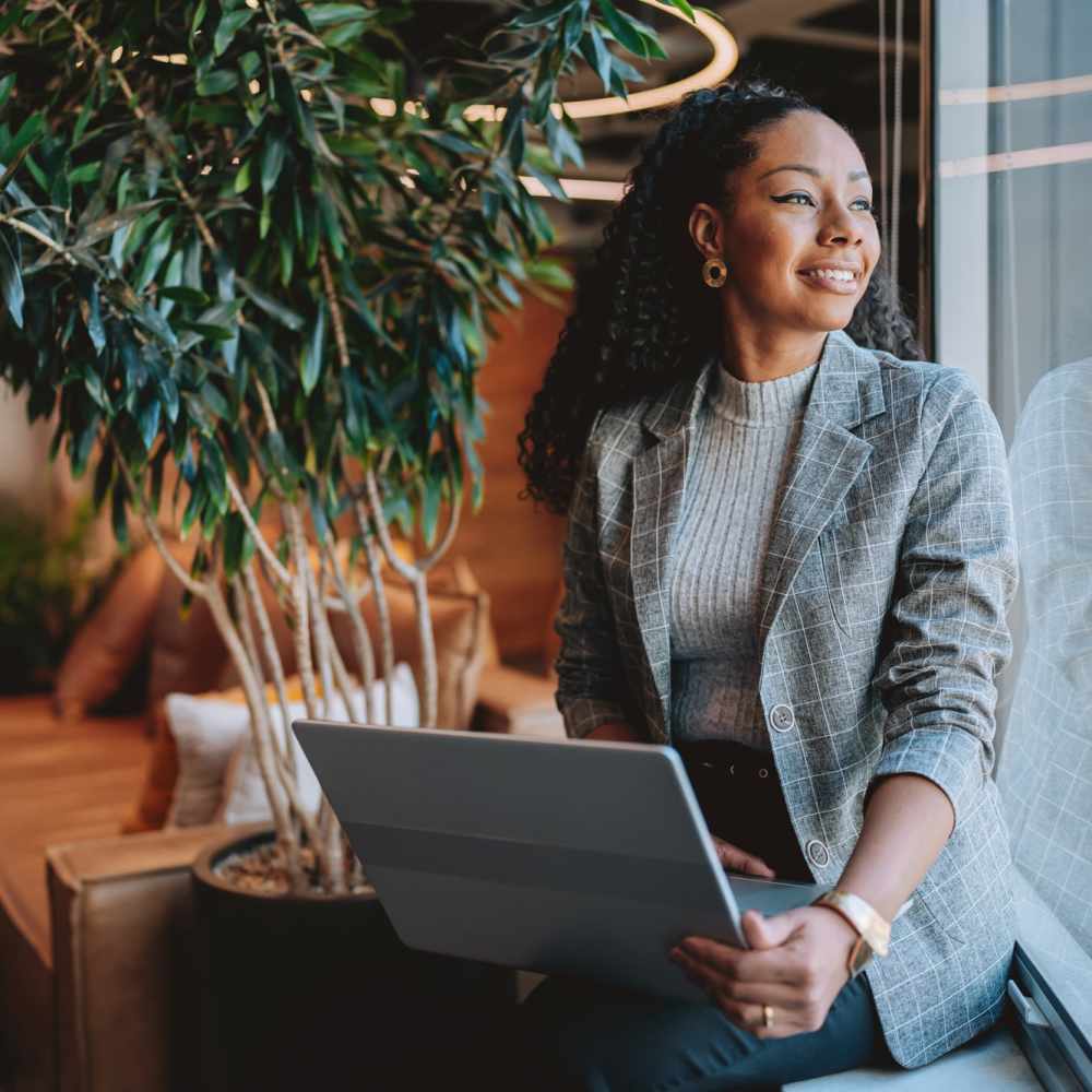 Woman with a laptop at Emerald Properties in San Lorenzo, California