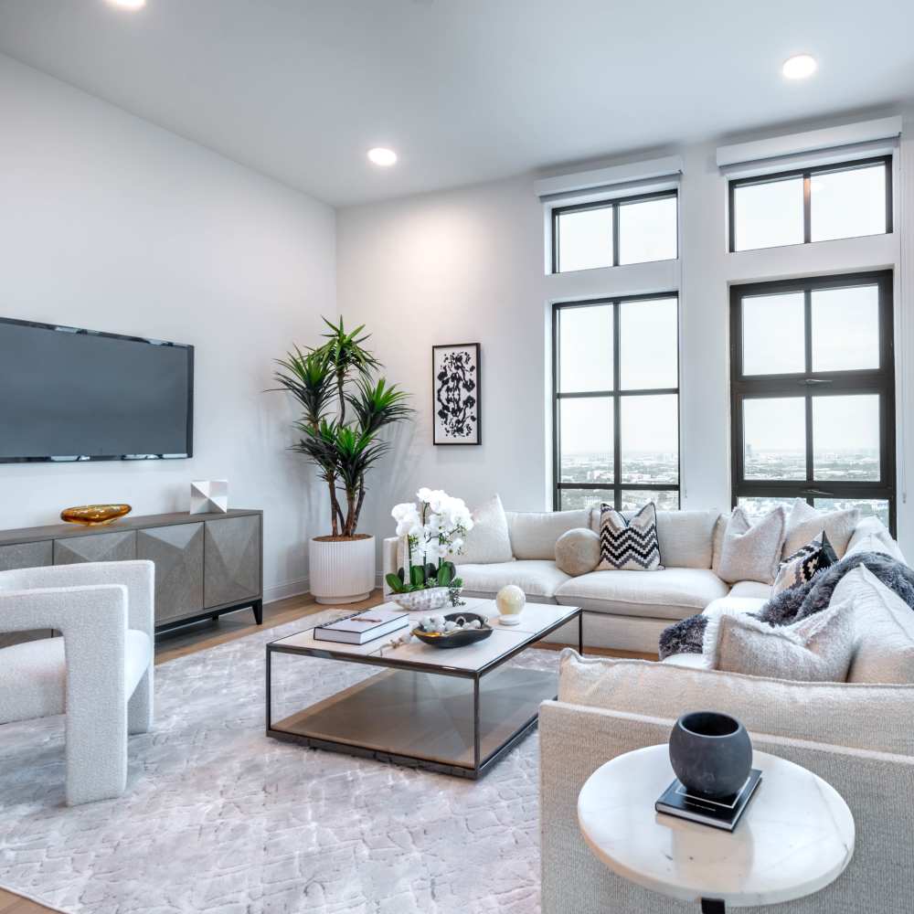 Bright living room with large windows at Novel Turtle Creek in Dallas, Texas