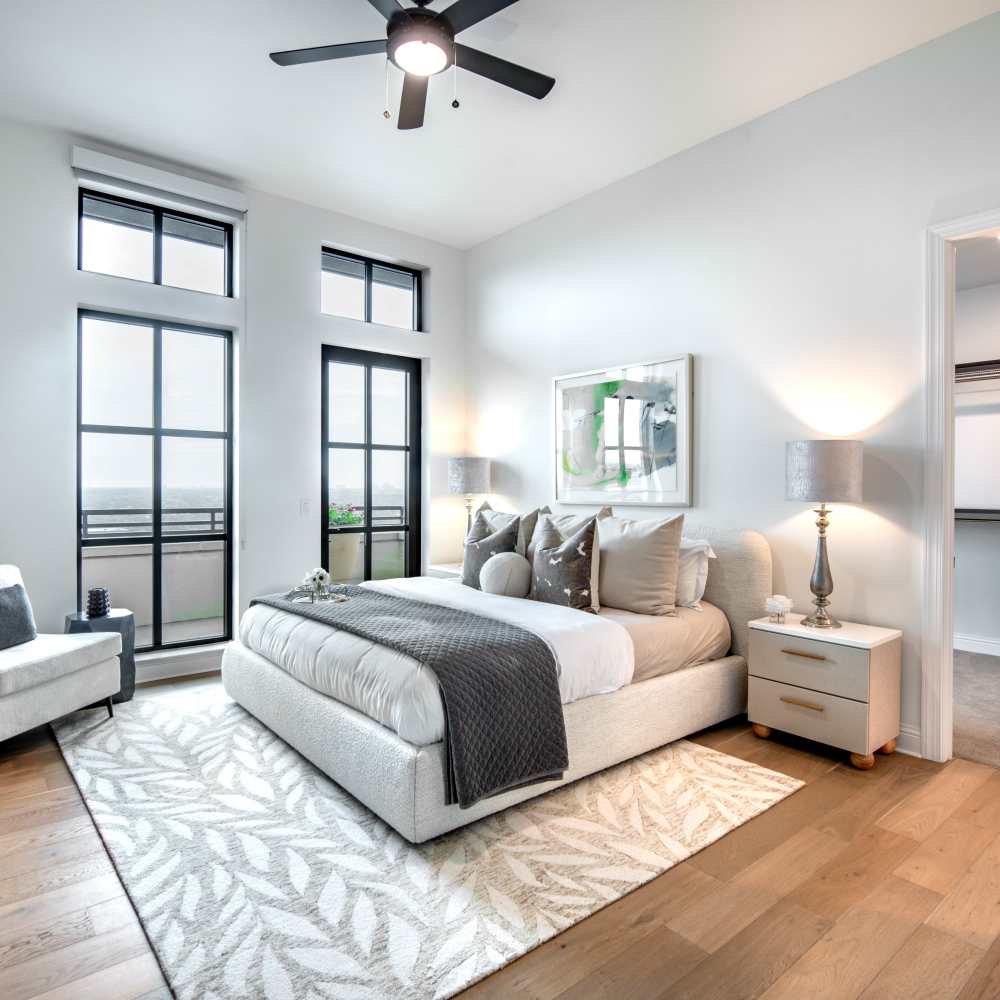 Bright bedroom with wood-style flooring and modern decor at Novel Turtle Creek in Dallas, Texas