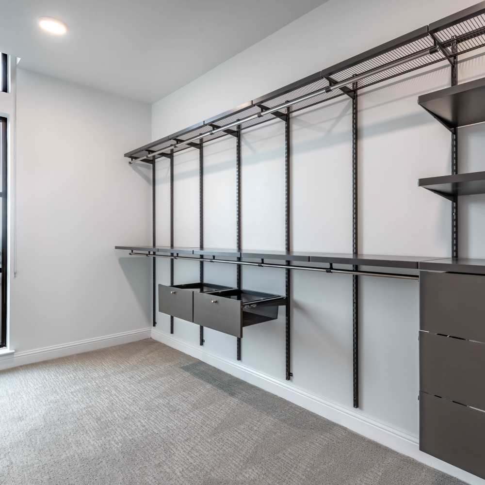 Spacious walk-in closet with shelving and drawers at Novel Turtle Creek in Dallas, Texas
