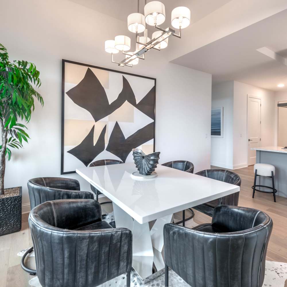 Modern dining area with sleek white table at Novel Turtle Creek in Dallas, Texas