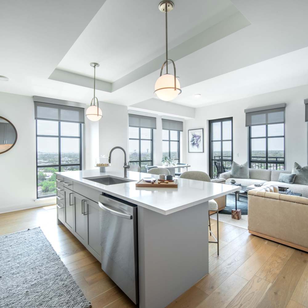 Modern kitchen with open layout featuring wood-style flooring at Novel Turtle Creek in Dallas, Texas