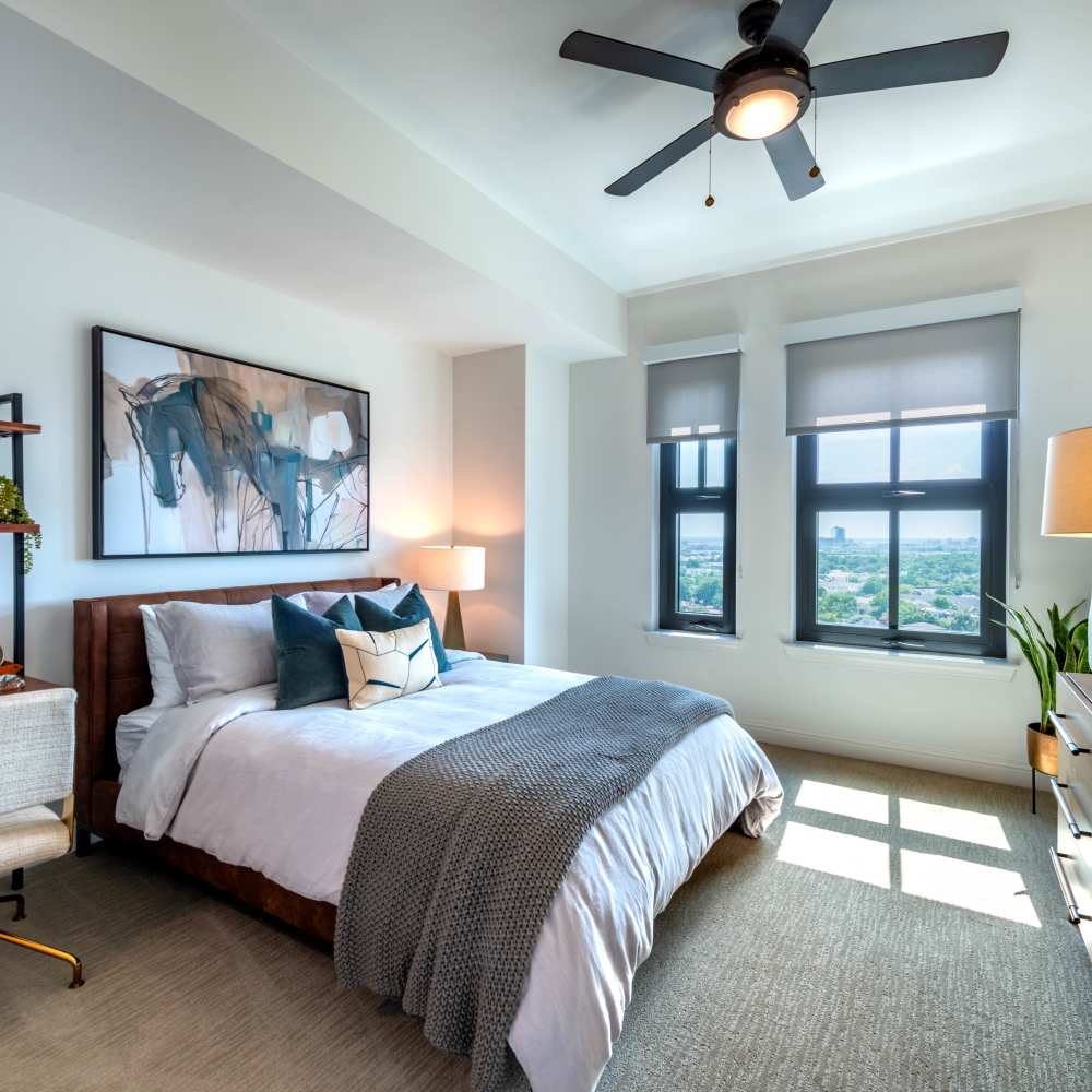 Bright bedroom with cozy bedding at Novel Turtle Creek in Dallas, Texas