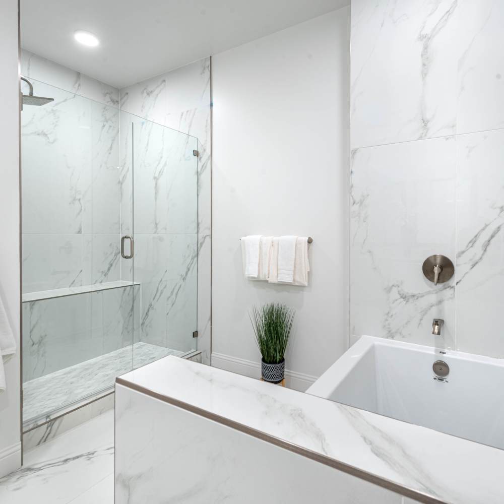 Modern bathroom featuring a glass shower at Novel Turtle Creek in Dallas, Texas