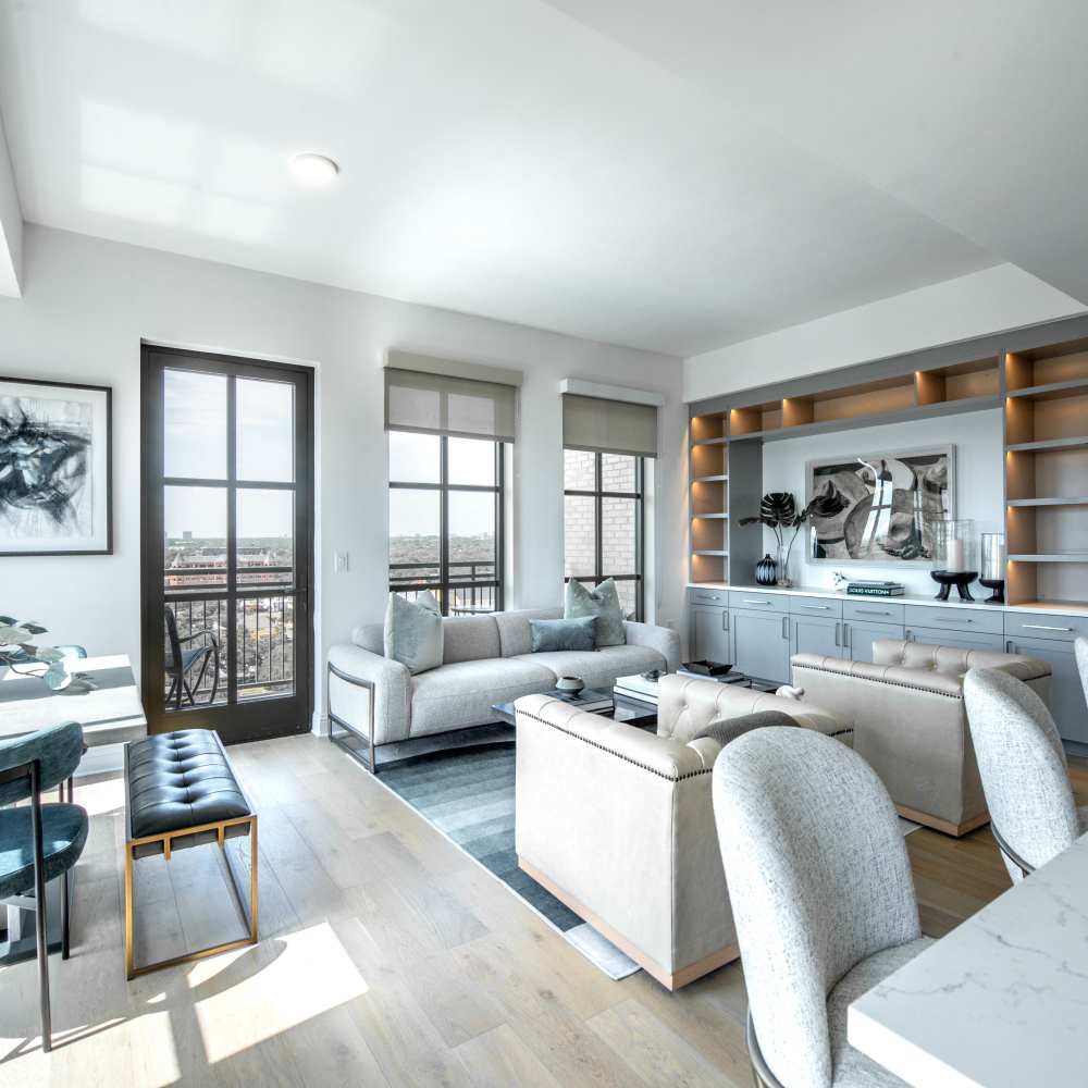 Bright living area with wood-style flooring at Novel Turtle Creek in Dallas, Texas