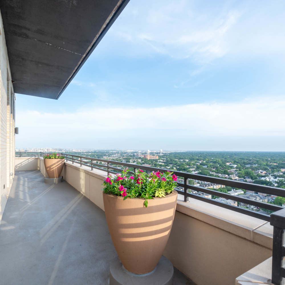 Spacious balcony with large flower pots at Novel Turtle Creek in Dallas, Texas