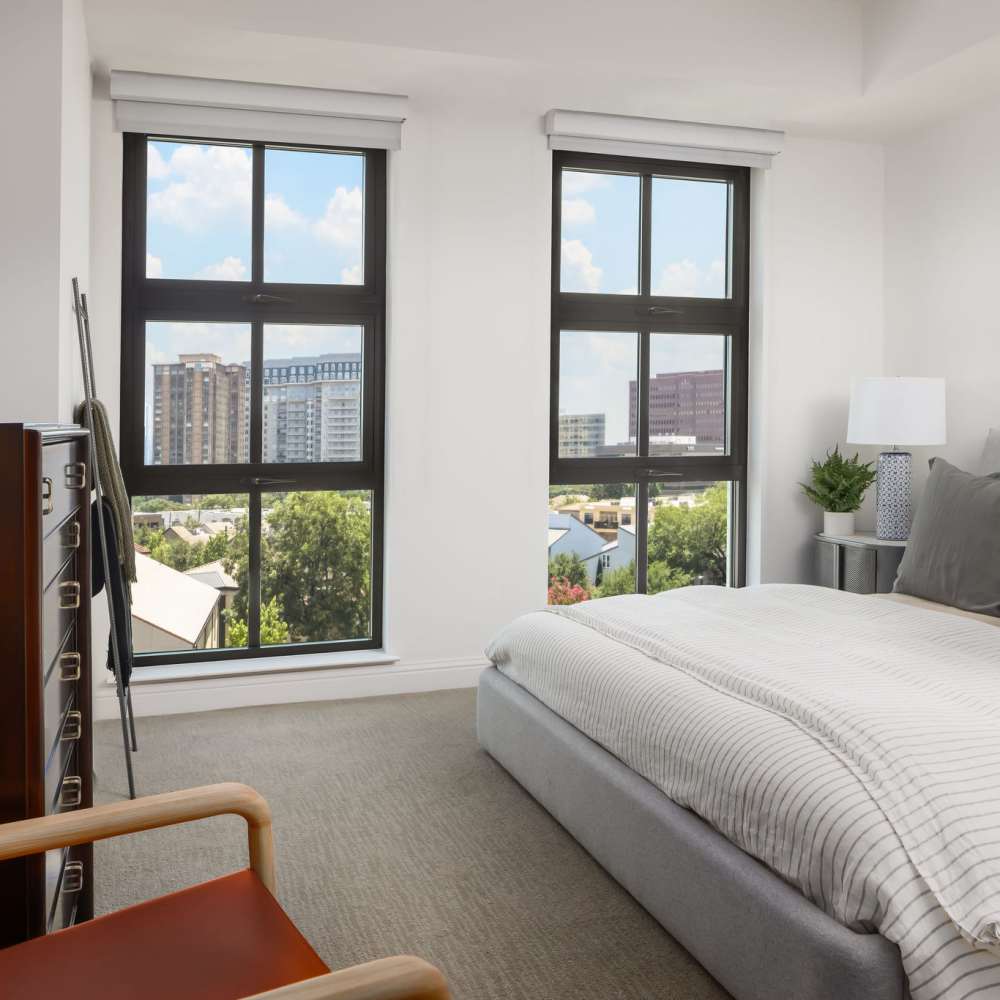 Bright bedroom with large windows at Novel Turtle Creek in Dallas, Texas