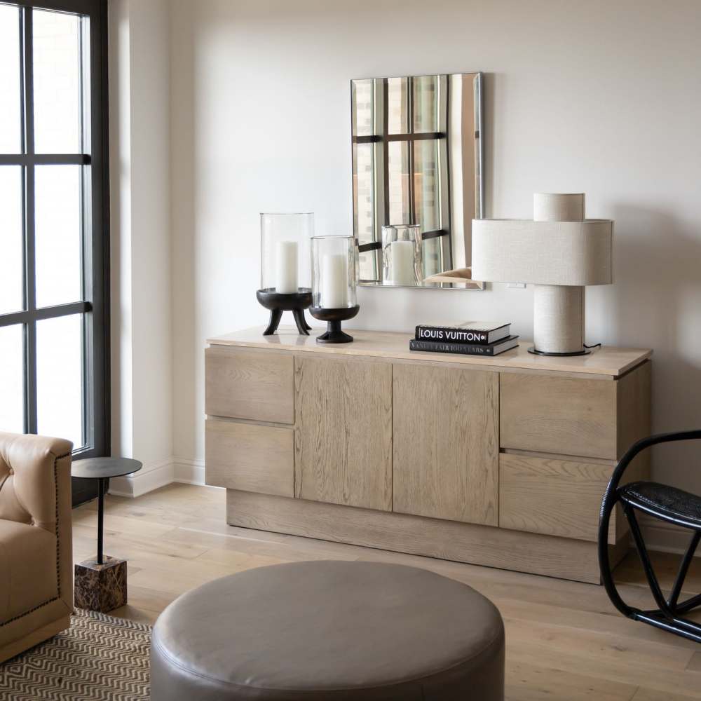 Stylish living room with wood-style flooring and modern decor at Novel Turtle Creek in Dallas, Texas