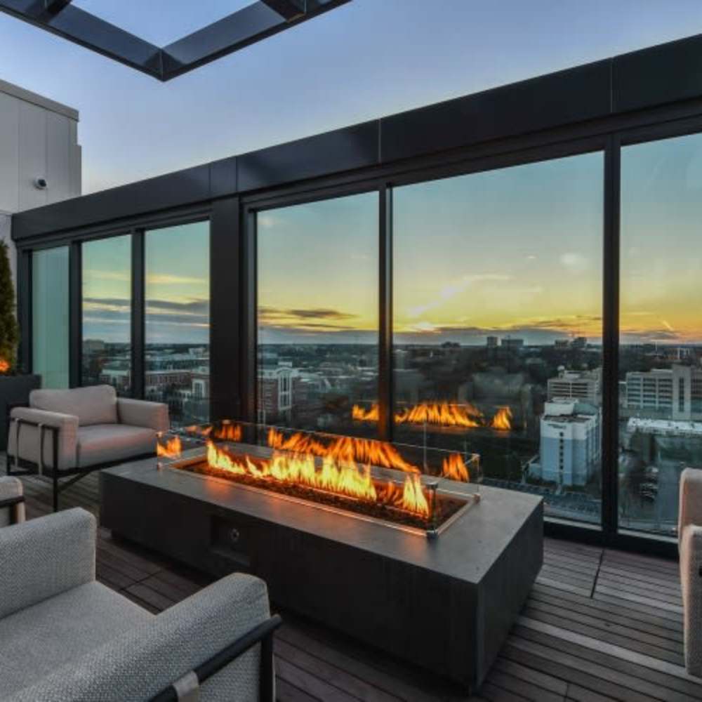Fire pit with flames and seating area at Novel Midtown in Atlanta, Georgia