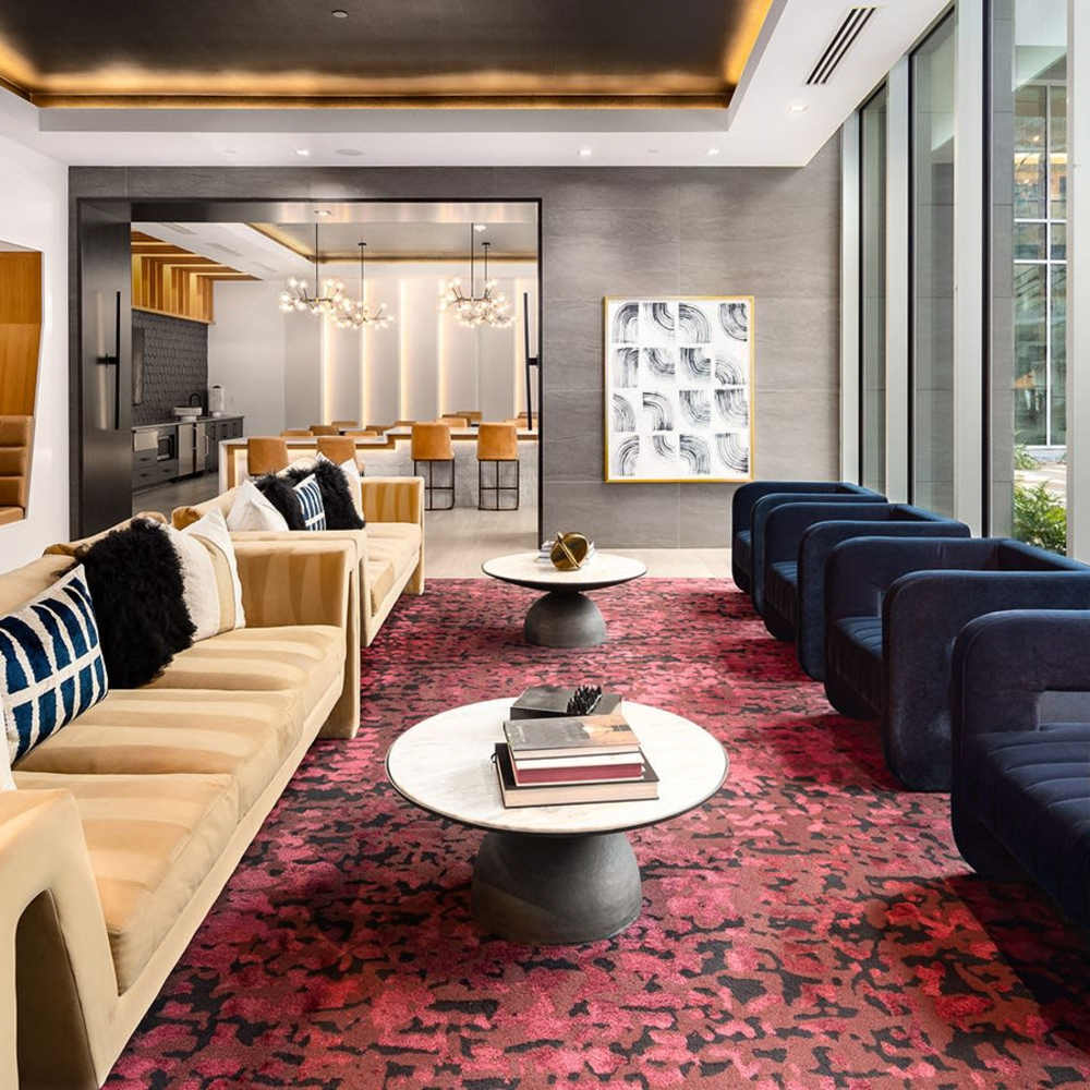 Round coffee tables with books and decor at Novel Midtown in Atlanta, Georgia