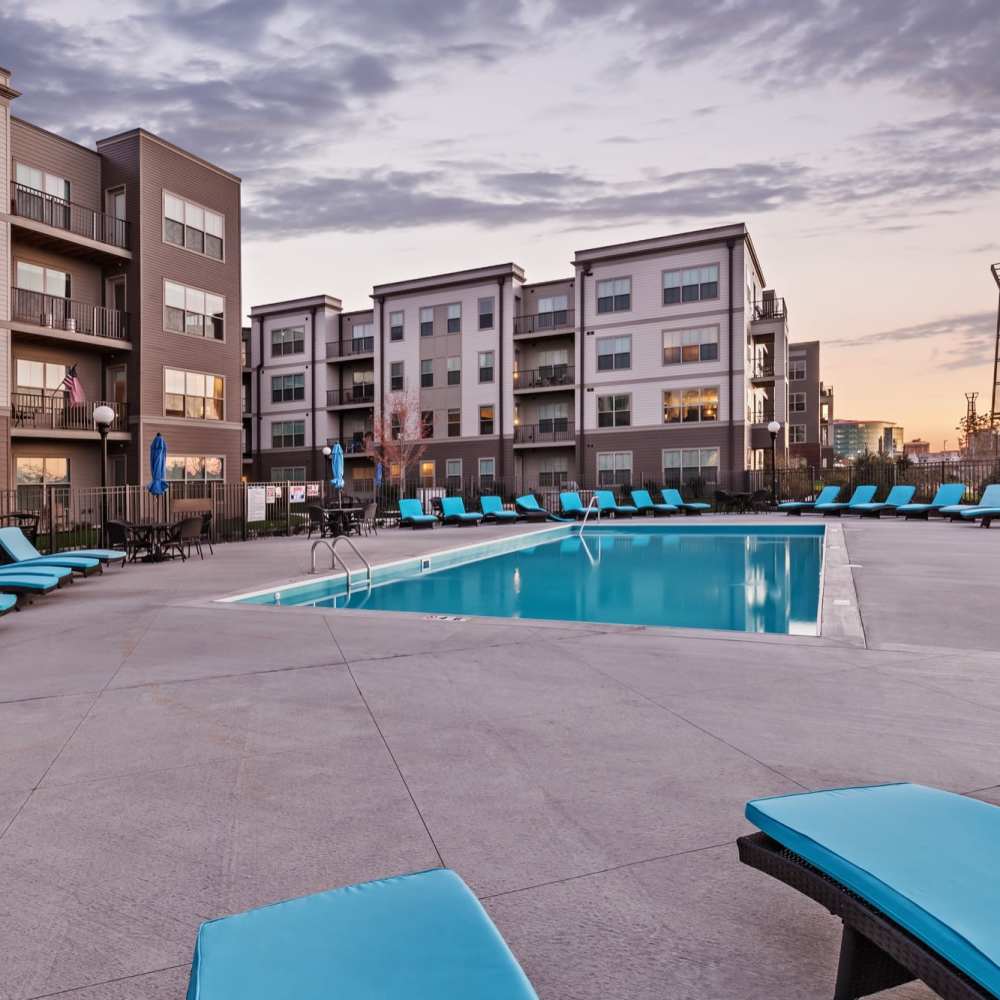 Lounge chairs by the swimming pool at Water Street Apartments in Dayton, Ohio