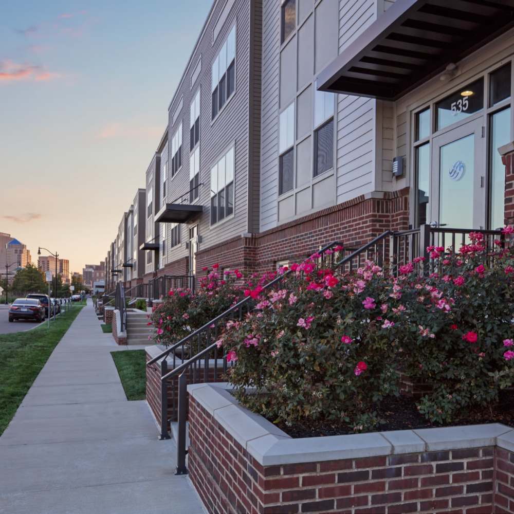 Vibrant flowers outside the building at Water Street Apartments in Dayton, Ohio