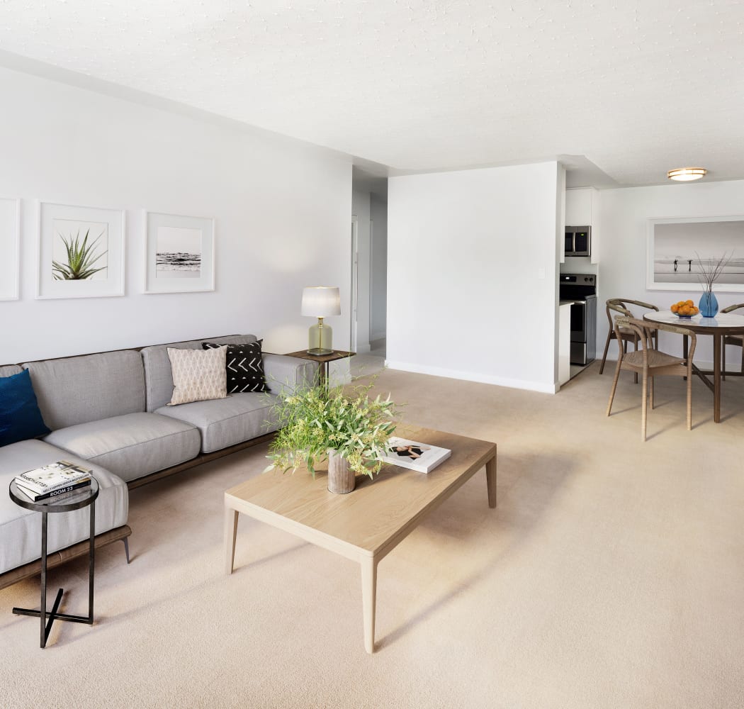 Lovely living room with beautiful coffee table at Fraser Tolmie Apartments in Victoria, British Columbia