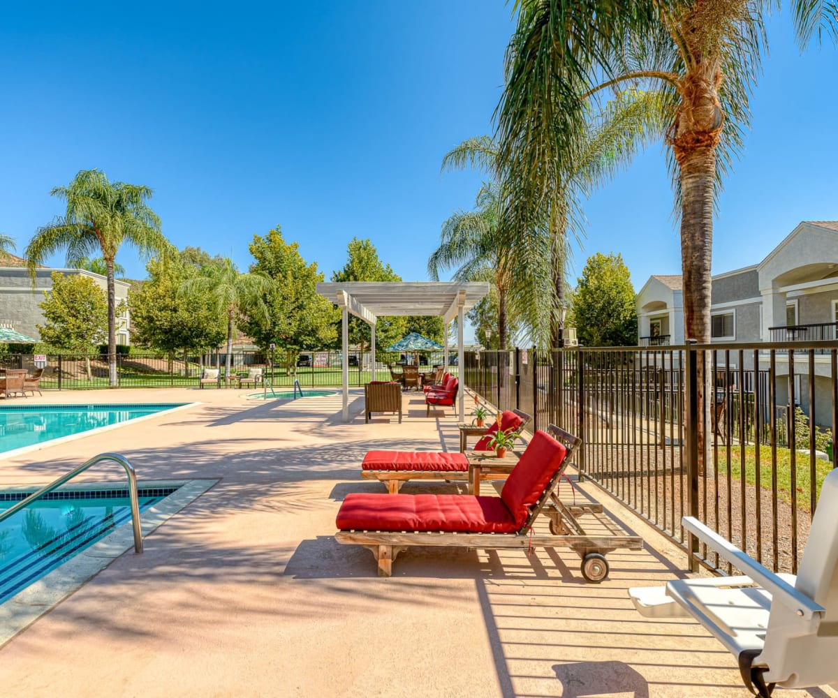 Pool with lounge chairs at Pacifica Senior Living Menifee in Sun City, California