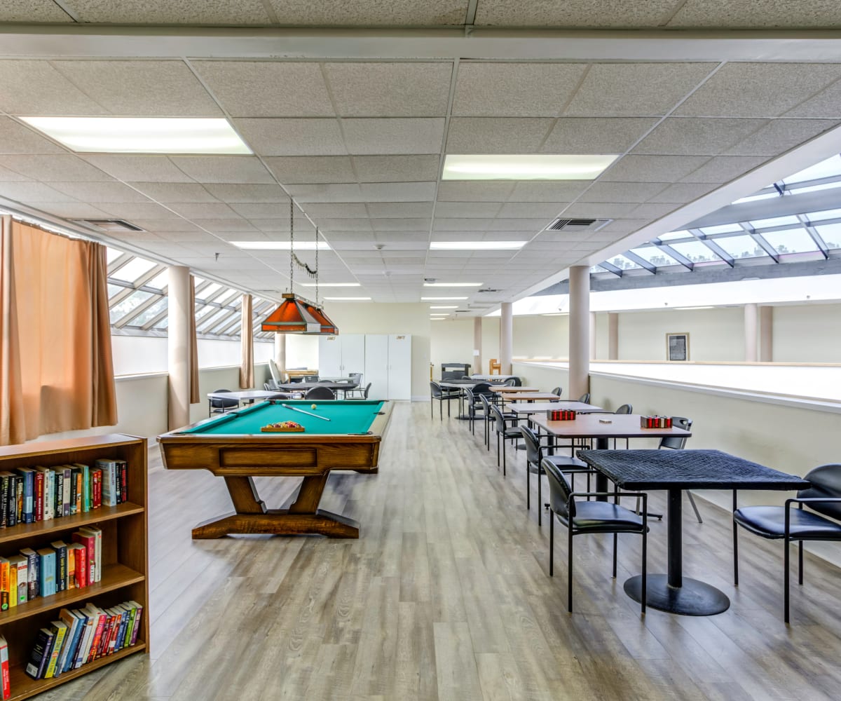 Atrium room with pool table and seating at The Lenox At Merritt Island in Merritt Island, Florida