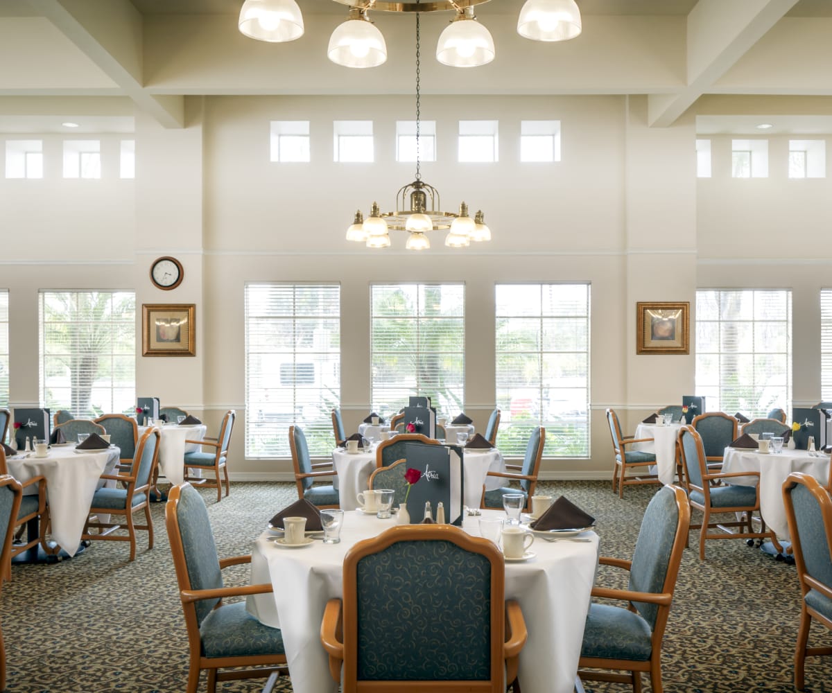 Spacious dining room with chandelier lighting at Pacifica Senior Living Bonita in Chula Vista, California