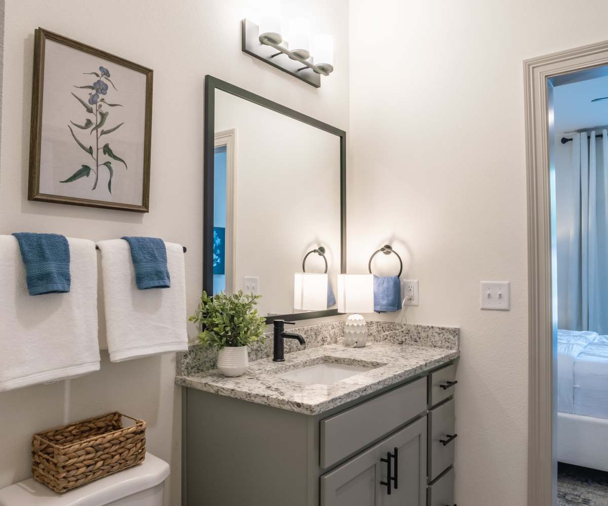 Modern-Style Bathroom with Mirror in front of Sink at The Waters at Freeport in Freeport, Florida