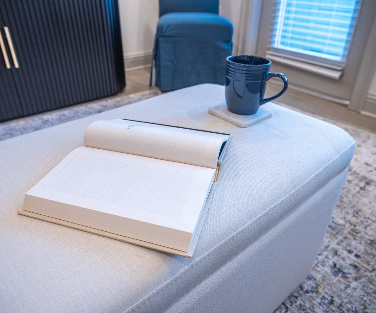 A Book and A Cup of Coffee at Top of Sofa in Living Room at The Waters at Freeport in Freeport, Florida