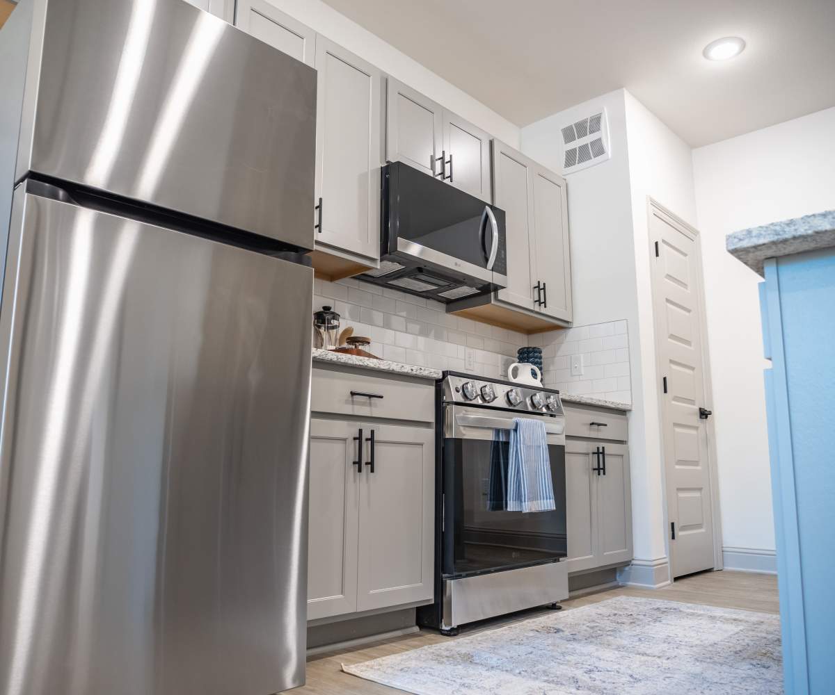 Kitchen with White Cabinets and Stainless steel Appliances at The Waters at Freeport in Freeport, Florida
