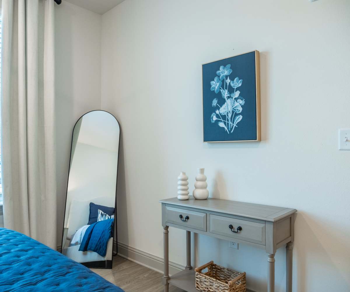 A Bedroom with Mirror and Small Table at The Waters at Freeport in Freeport, Florida