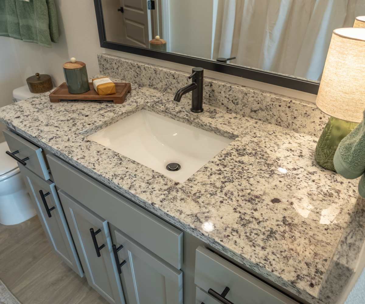 Sink with Granite top and mirror at The Waters at Freeport in Freeport, Florida