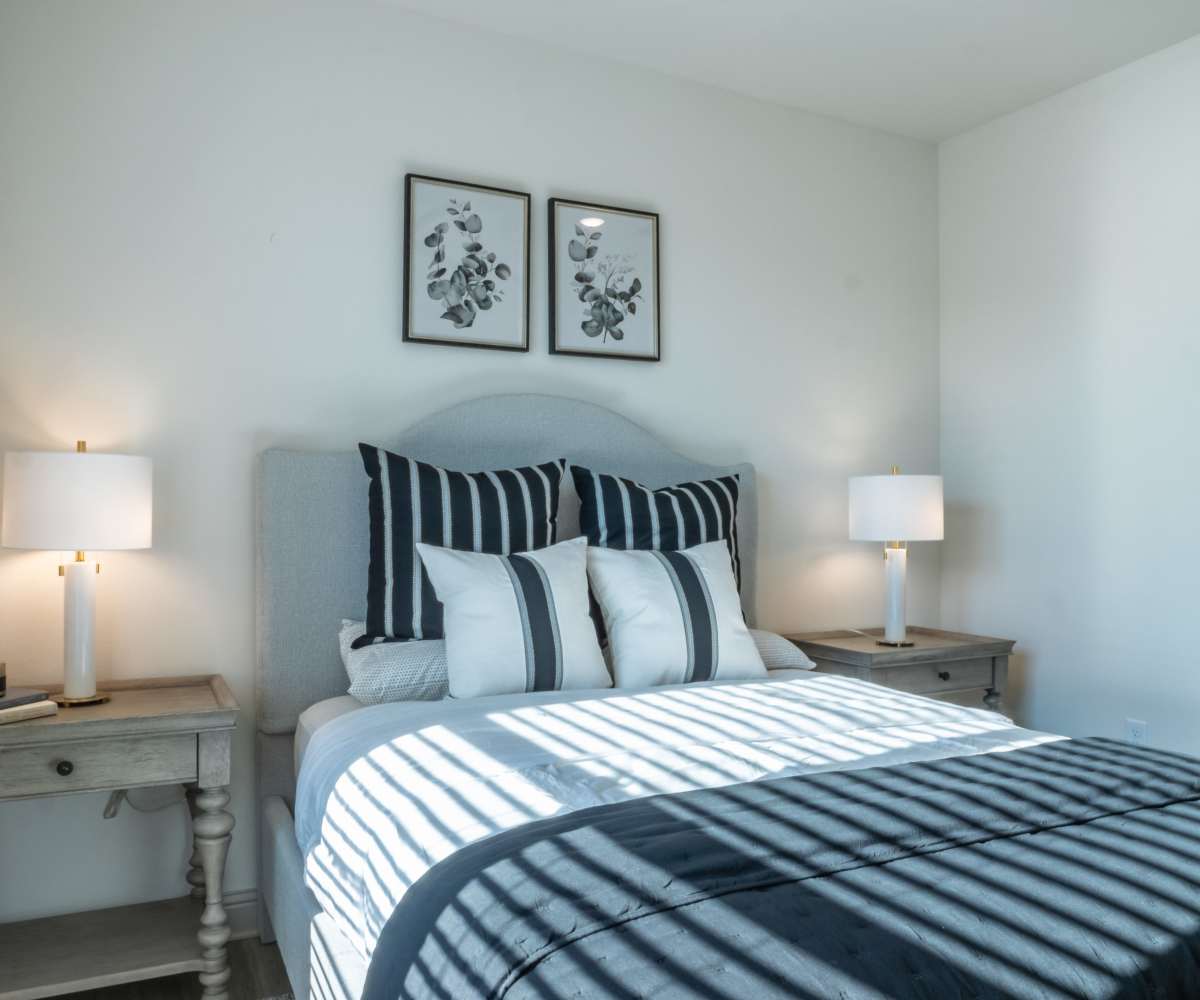 Modern-Style Bedroom with blue and white bedsheet at The Waters at Freeport in Freeport, Florida