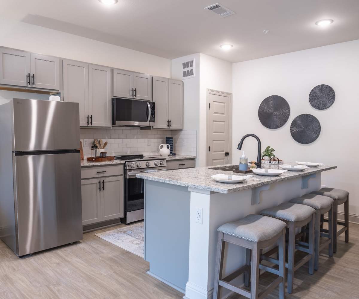 Kitchen with Stainless Steel Appliances & Granite Countertops at The Waters at Freeport in Freeport, Florida