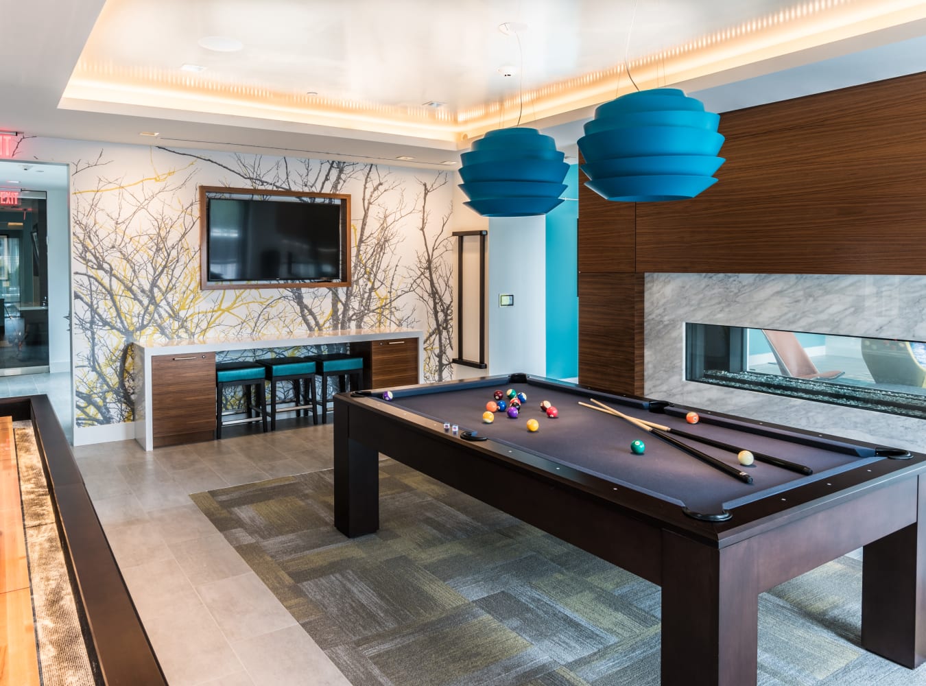 A billiards room with a TV at Solaire 7077 Woodmont in Bethesda, Maryland