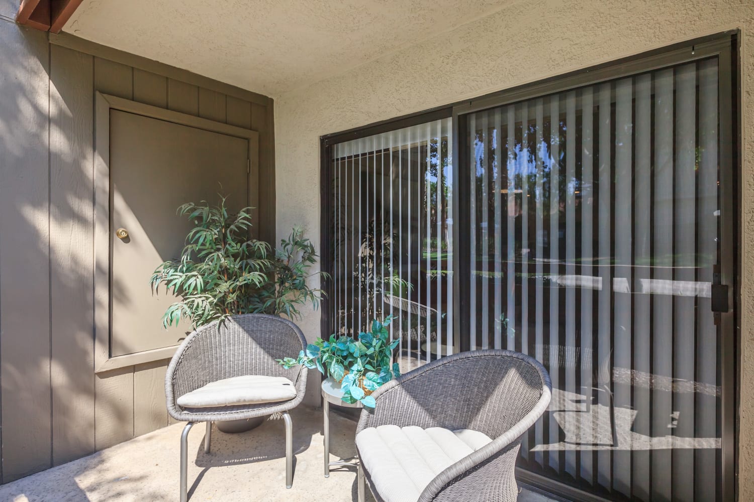 Sunny private patio at Parcwood Apartments in Corona, California