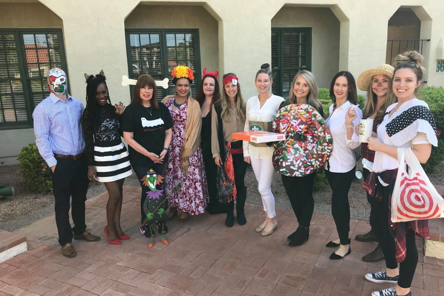 Group of Mark-Taylor costumed employees posing for a Halloween photo 