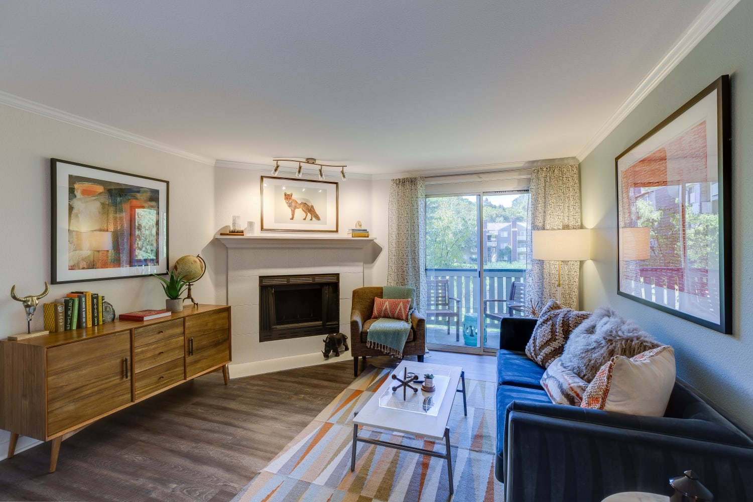 Spacious living room with fireplace and wood floors at The Preserve at Forbes Creek in Kirkland, Washington