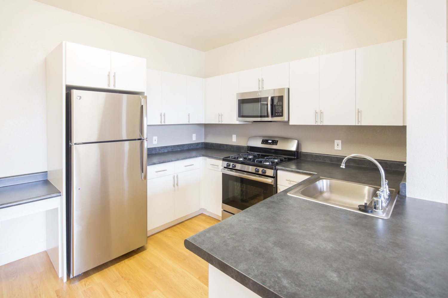 Stainless steel appliances and updated counter tops at Park Hacienda Apartments in Pleasanton, California
