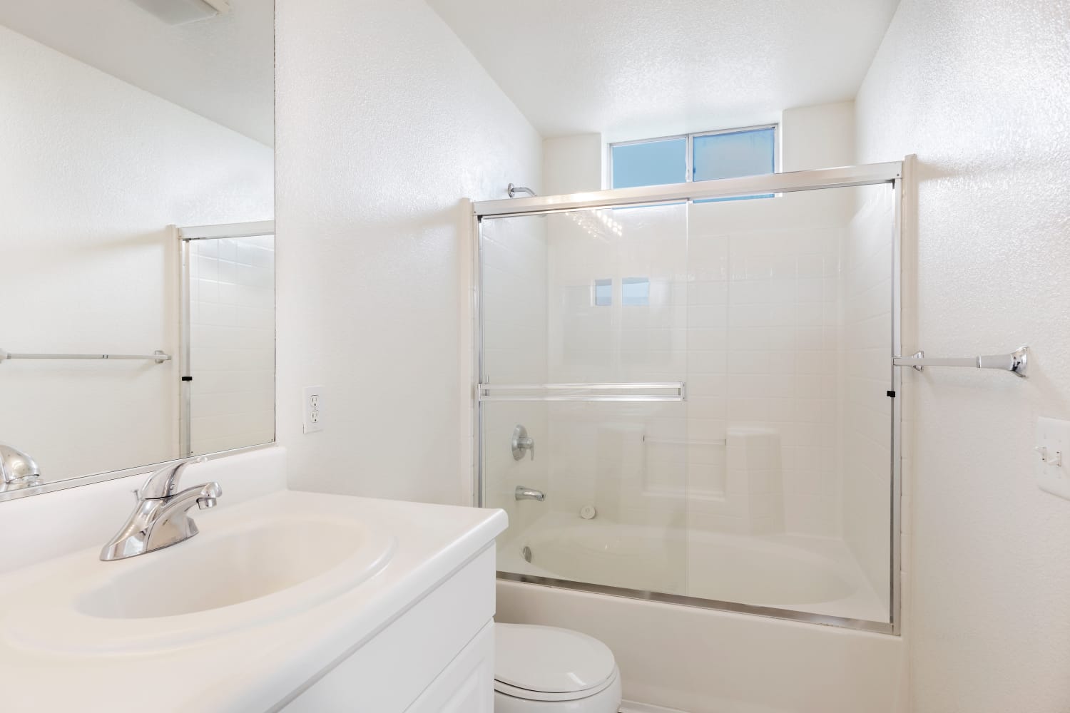 A bright, white bathroom at Park Hacienda Apartments in Pleasanton, California