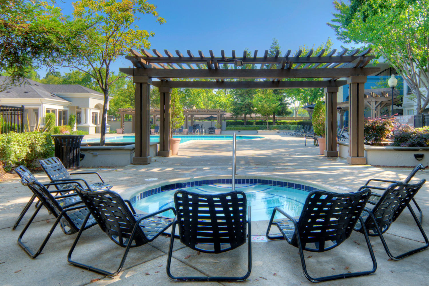 Chairs around the pool area at Park Hacienda Apartments in Pleasanton, California