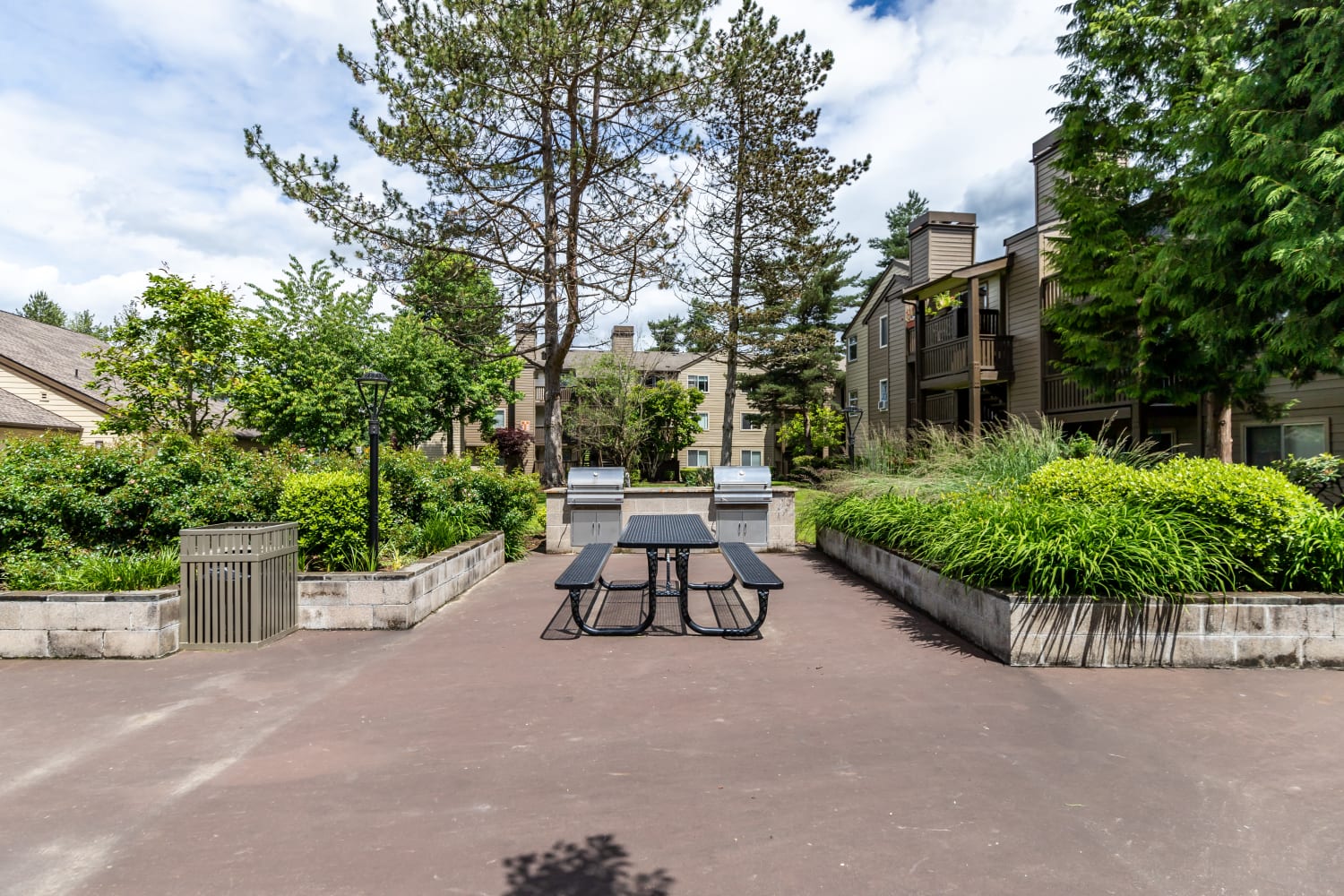 Outdoor community picnic and BBQ space at Campbell Run Apartments in Woodinville, Washington