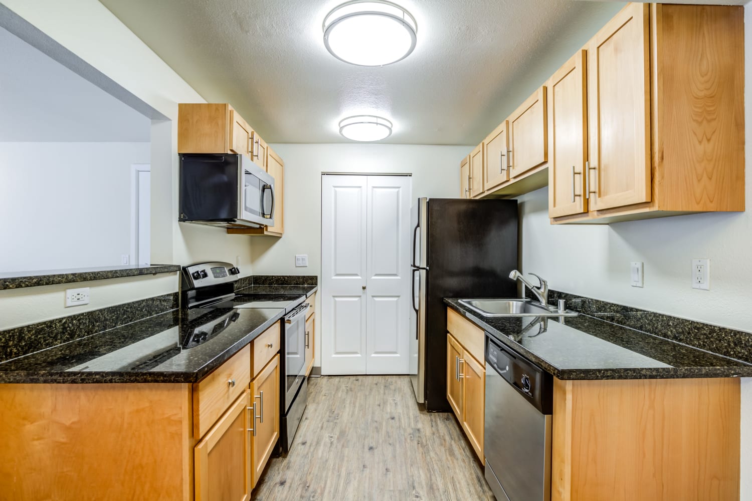  Kitchen with black finished appliances and lots of cabinet storage space at Campbell Run Apartments in Woodinville, Washington