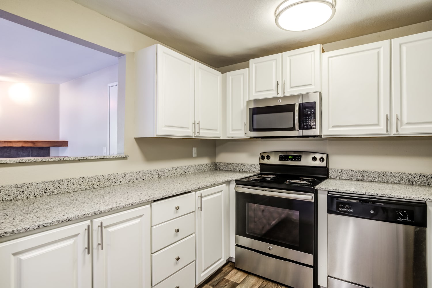 Modern Kitchen with stainless steel appliances and ample countertop space at Campbell Run Apartments in Woodinville, Washington
