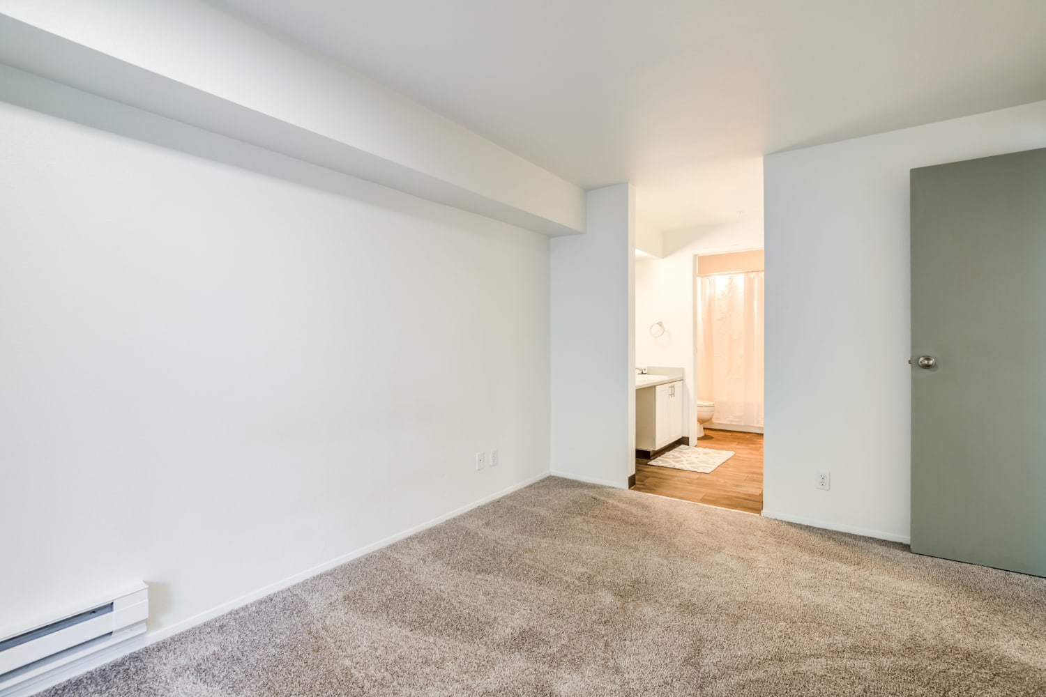 Comfortable bedroom with bathroom access at Metropolitan Park Apartments in Seattle, Washington