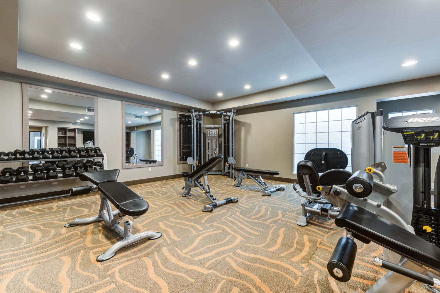 Exercise equipment and free weights in the fitness center at The Bluffs in Rancho Cucamonga, CA