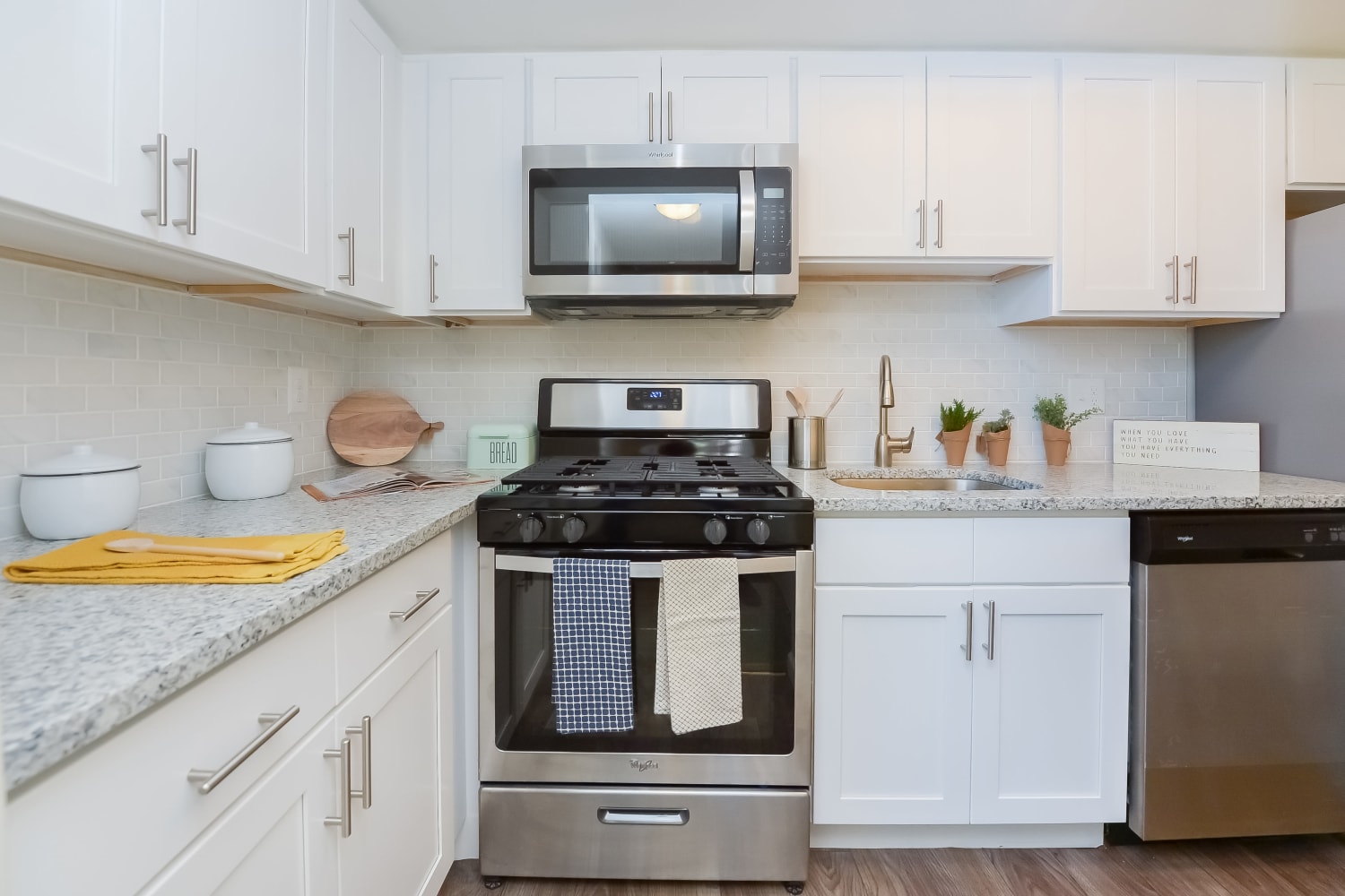 Contemporary kitchen with stainless-steel appliances at Strafford Station Apartments in Wayne, Pennsylvania