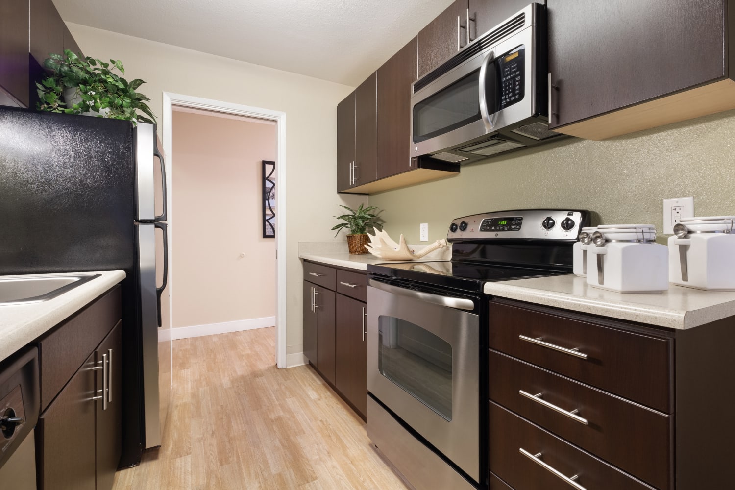 Kitchen with cark cabinets at Harbor Cove Apartments in Foster City, California