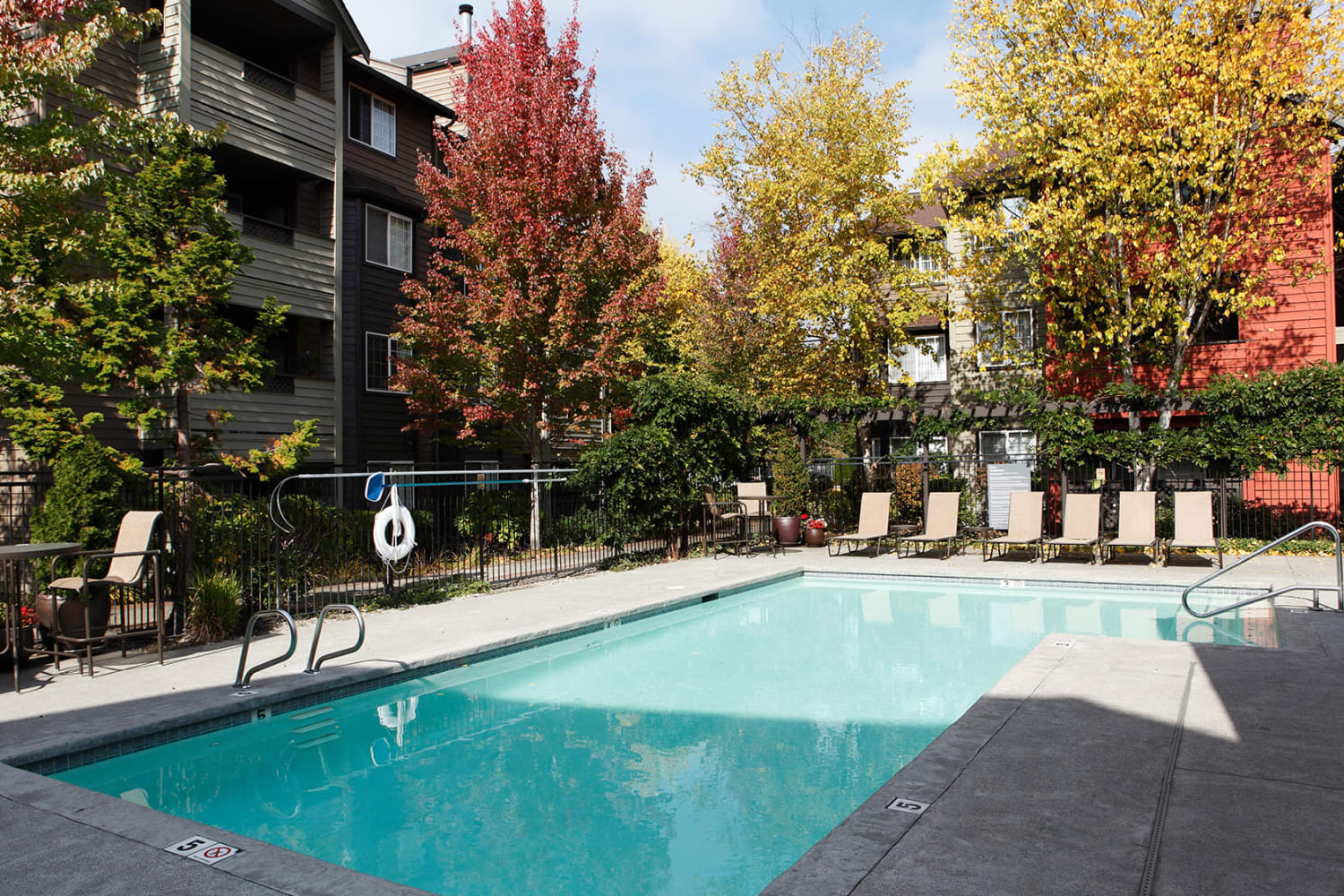 Pool with lounging chairs at Redmond Place Apartments in Redmond, Washington