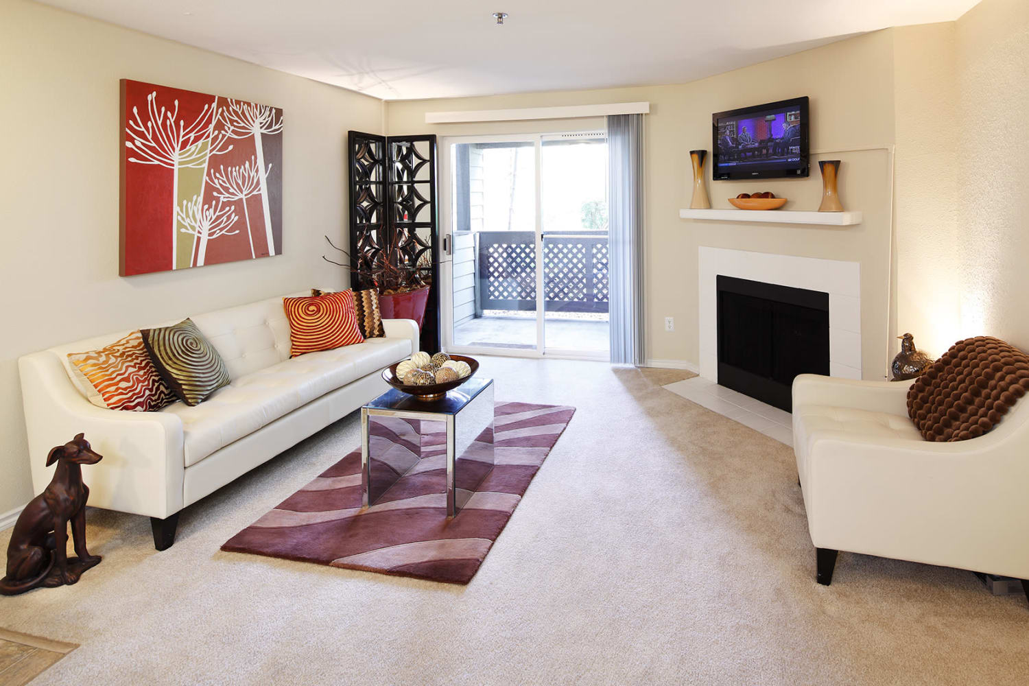View of spacious living room and balcony at Redmond Place Apartments in Redmond, Washington