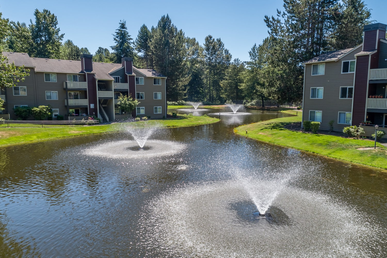 Fountains in pond outside of community buildings at The Preserve at Forbes Creek in Kirkland, Washington