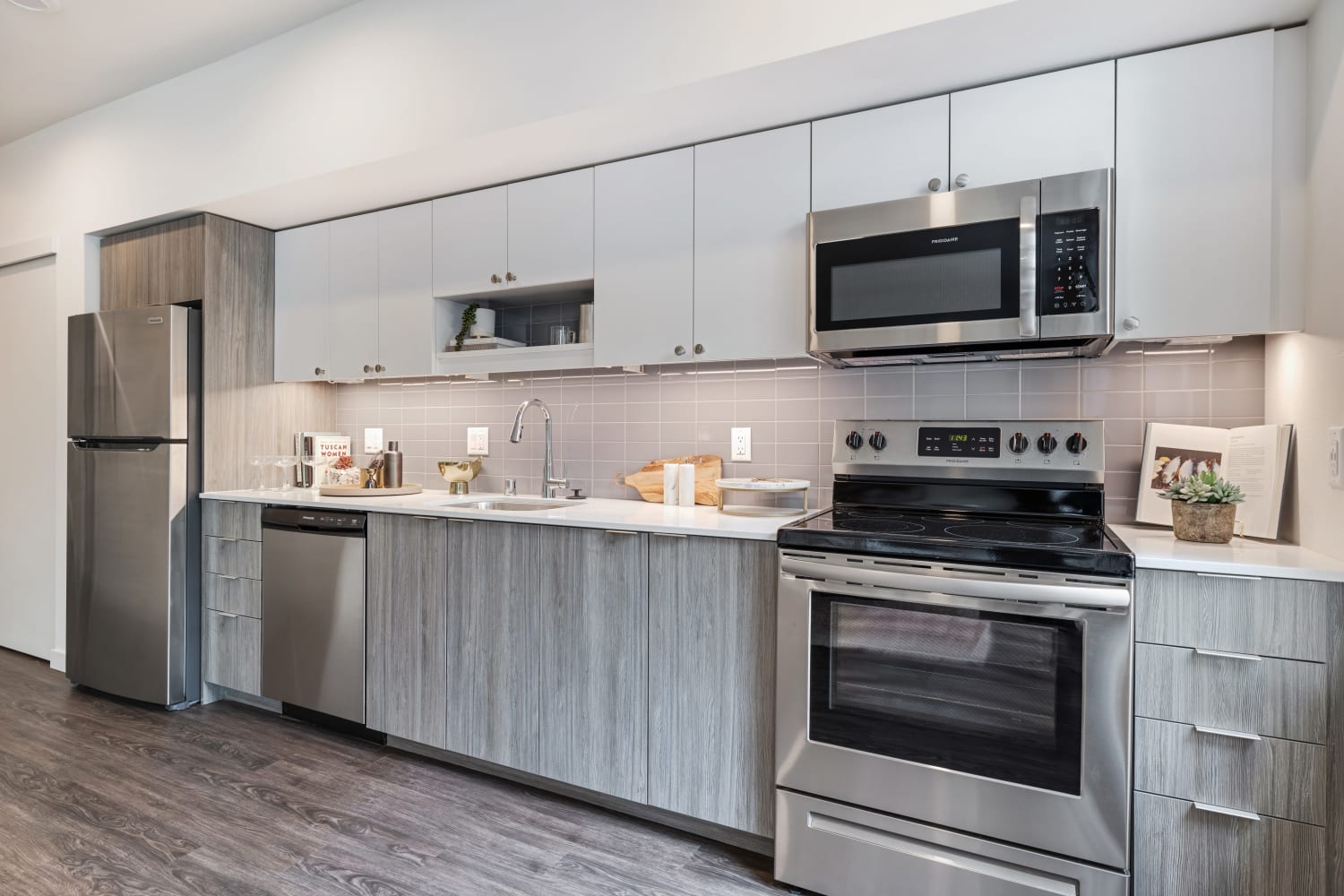 Model kitchen with stainless-steel appliances and chef's island at Nightingale in Redmond, Washington