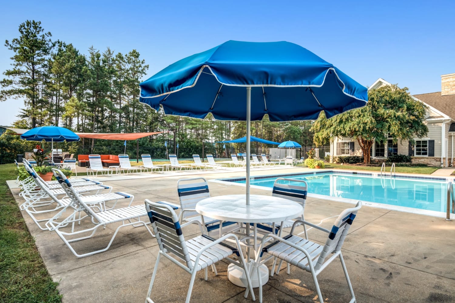 Table near swimming pool at St. Mary's Landing Apartments & Townhomes in Lexington Park, Maryland