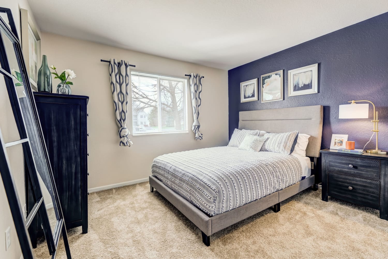 Master bedroom with plush carpeting at Steeplechase Apartments & Townhomes in Toledo, Ohio