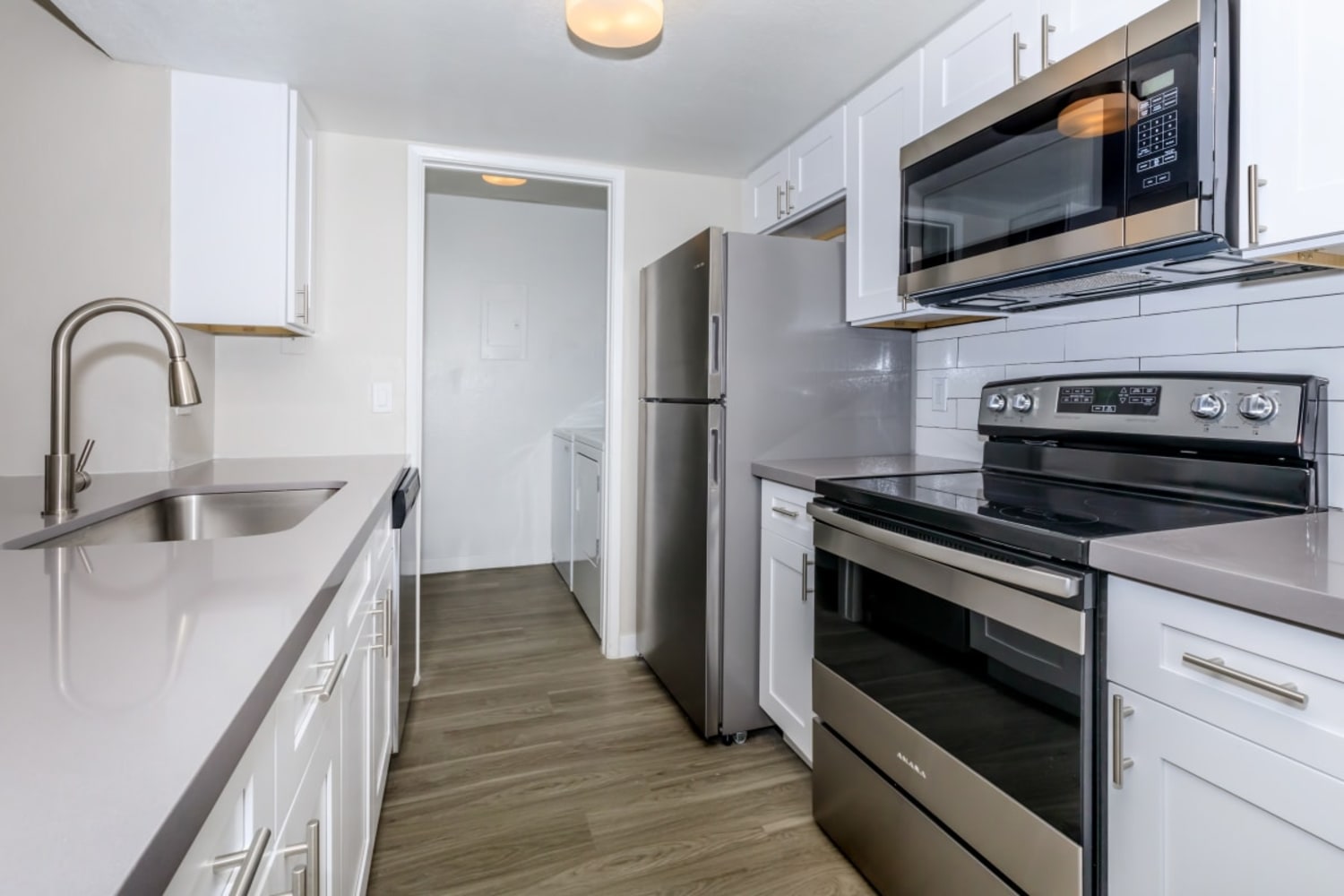A bright kitchen with stainless-steel appliances at Station 21 Apartments in Mesa, Arizona